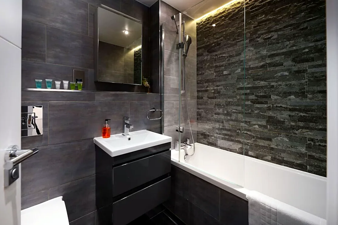 Bathroom with bath and shower