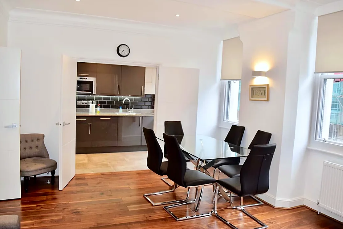 Dining table with the kitchen beyond