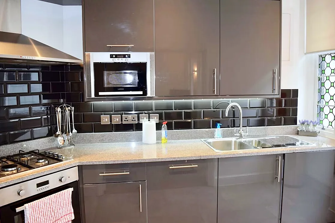Kitchen with microwave, sink and stained-glass window