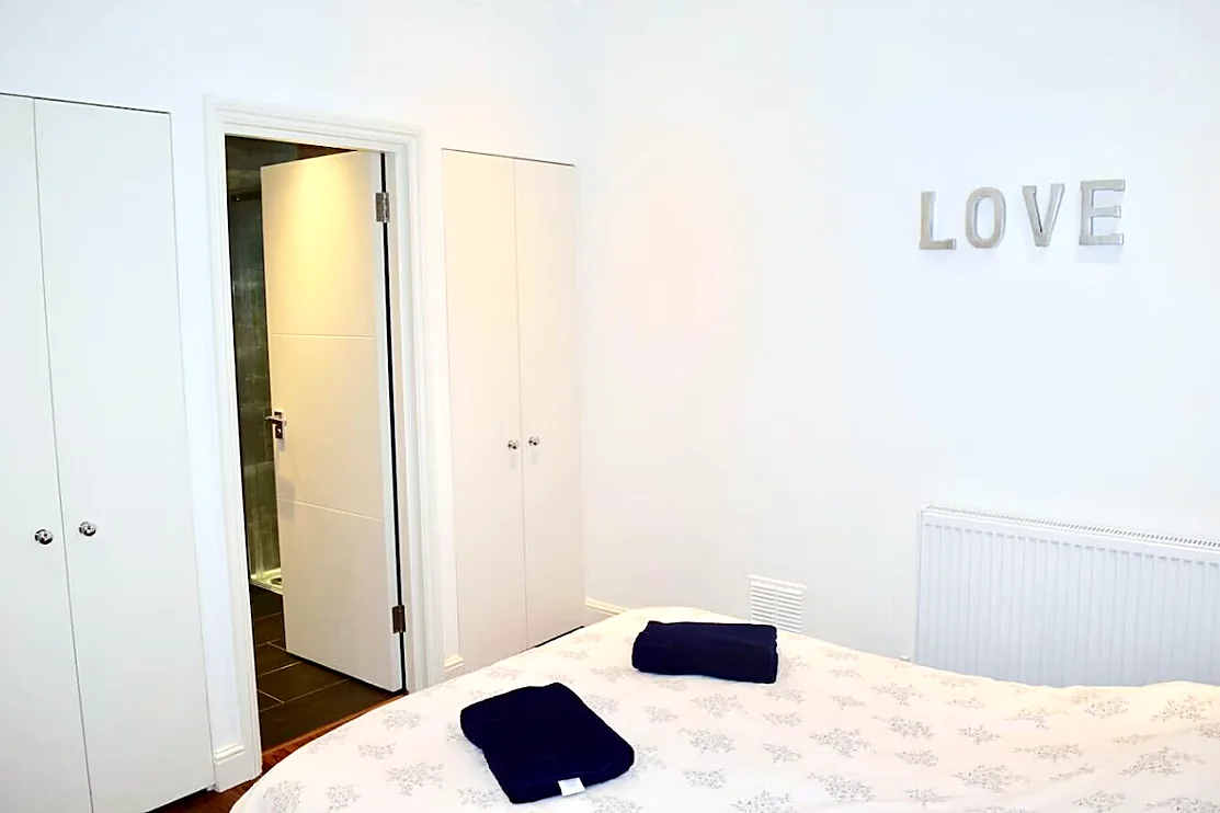 Bedroom with wardrobes and bathroom door
