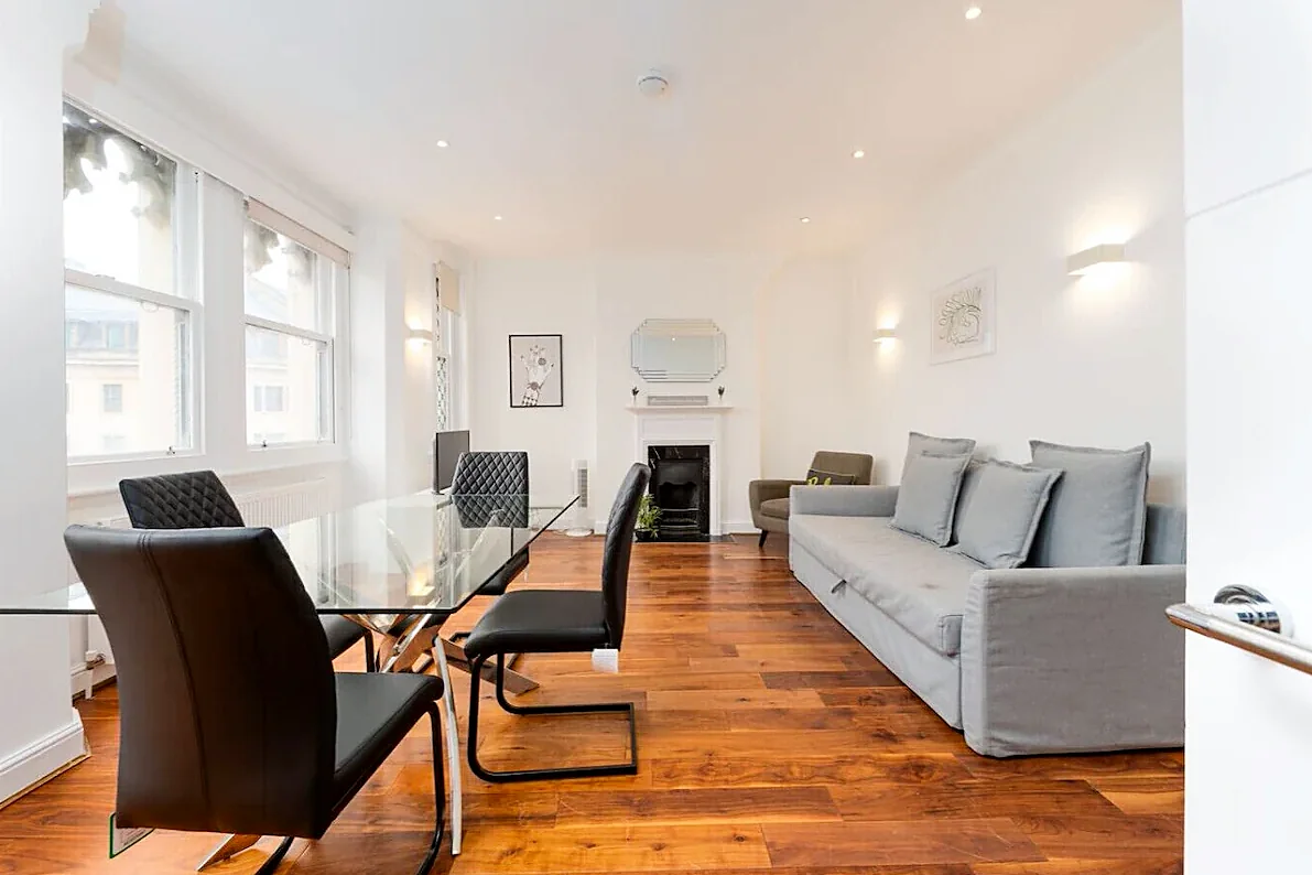 Apartment 3: Living and dining room with walnut floors and tall windows